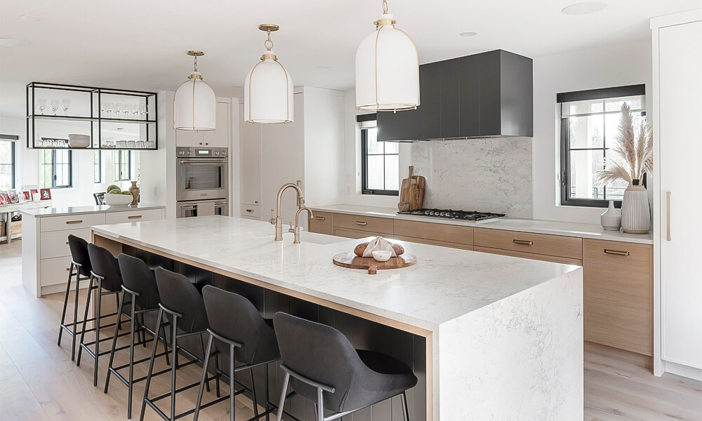 A modern one-wall kitchen featuring sleek wood veneer cabinets and a luxurious marble central island. The combination of warm wood textures and elegant marble creates a sophisticated and inviting cooking space with a clean, contemporary aesthetic.