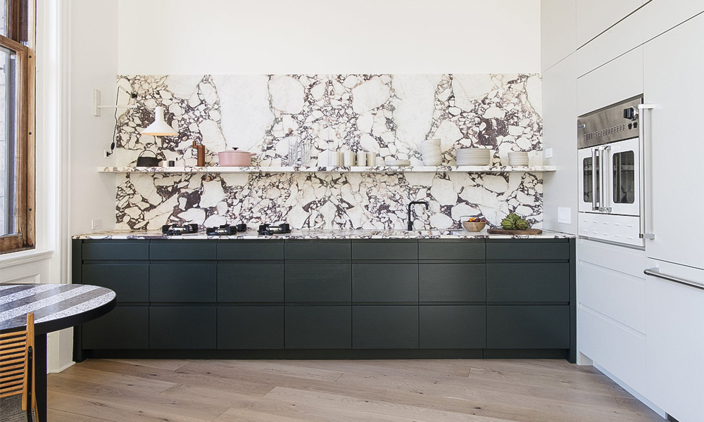 A one-wall kitchen featuring deep gray cabinetry. The rich gray tones of the cabinets provide a sleek, modern aesthetic, while the one-wall layout ensures a functional and efficient design, making the space both stylish and practical.