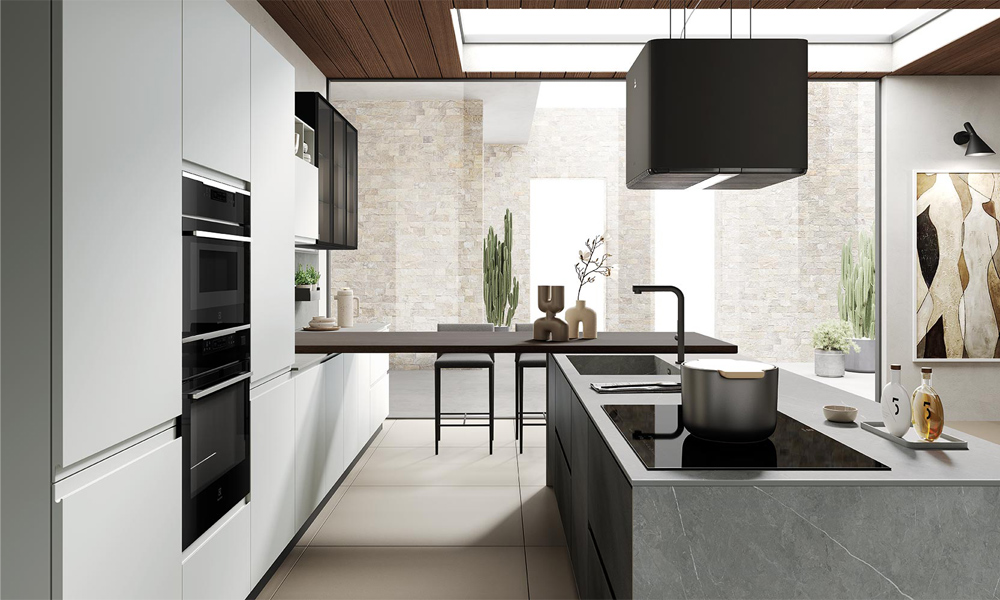 A close-up view of an L-shaped kitchen with dark gray lacquered cabinets, showcasing the sleek, glossy surface. The image highlights the central countertop, seamlessly integrated into the design, offering a clean, modern aesthetic. The combination of dark cabinets and the smooth countertop surface creates a sophisticated and contemporary atmosphere.