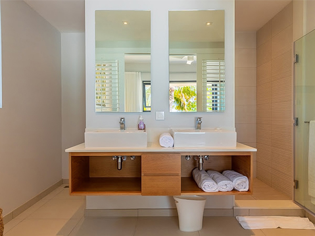 Project case image for Manta Cove by Horizon Holidays, located in Mauritius. The image showcases a stylish bathroom vanity, featuring sleek cabinetry with modern finishes, a spacious countertop, and contemporary design details. The vanity enhances the luxurious feel of the bathroom, providing both functionality and elegance in the holiday resort’s interior.
